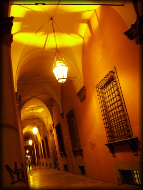 Arcades at night, person coming forward.