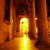 Arcades at night, man coming forward.