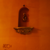 A nich in the wall for a Madonna and child, grafitti on the wall below.