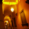 Arcades at night, person coming forward.