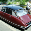 A Citroen DS and a guy on a bicycle passing by.