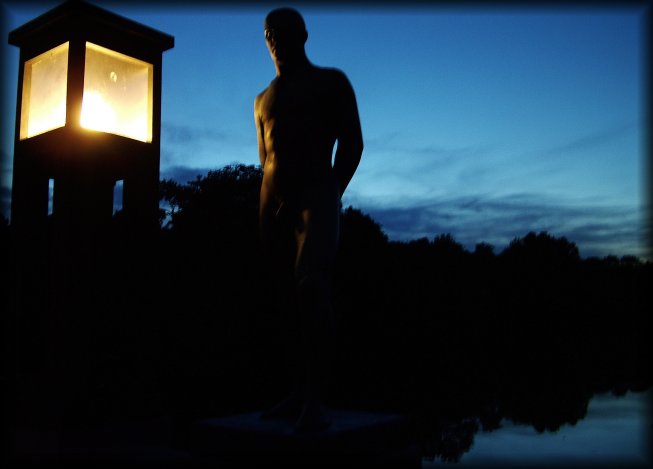This is a night shot! (00:25) It just doesn't get quite dark in Olso right now.  Sculpture of a man on the bridge in the Vigeland Sculpture Park.