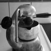 Coffee is slowly brewing on the stove, from a pretty vintage Atomic espresso maker.