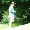 chaals barefoot (although it doesn't show clearly) in the grass.