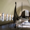 The Oseberg Ship at the Viking Ship Museum.  <em>The Oseberg Ship was found in a large burial mound at the Slagen farm in Vestfold and excavated in 1904. The ship was built in around 815-820 A.D. and had been used as a sailing vessel for many years before it was put to use as a burial ship for a prominent woman who died in 834. The ship, built of oak, was 22 meters long and 5 meters wide. The 12 strakes were secured with iron nails. The ship was designed for both rowing and sailing. With a square sail of about 90 sq. m., it could reach speeds of over 10 knots. The top strake had 15 oar holes.</em>  <em>The skeletons of two women were found in the grave. One, aged 60-70, suffered badly from arthritis and other maladies; the second was aged 25-30. It is not clear which one was the most important in life, or whether one was sacrificed to accompany the other in death. Although the high-ranking woman's identity is unknown, it has been suggested that it is the burial of Queen Asa of the Ynglinge clan, mother of Halfdan the Black and grandmother of Harald Fairhair. This theory is now generally dispelled, and it is now thought that she may have been a priestess.</em>