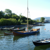 Rowing boats and sailing boat moored in the Oslo Fjord.