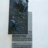 A 3D plaque next to the entrance of the academy of music and theatre.