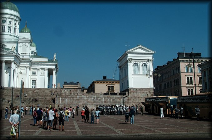 A crowd of soldiers and tourists in front of the Helsinki Cathedral.
