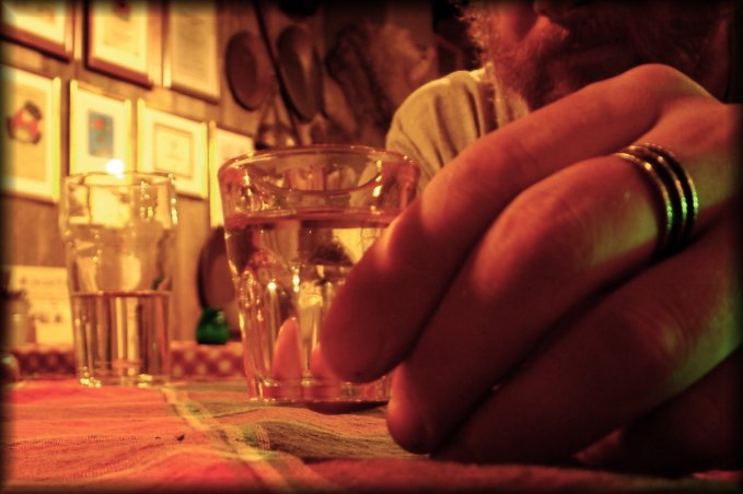 A tiny glass, a huge hand and a big glass.