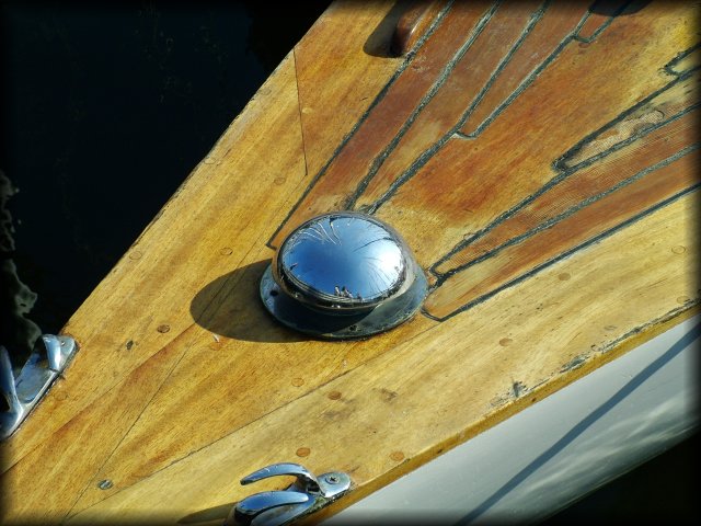 A fish-eye reflection where masts converge.