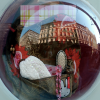 Buildings reflected in the window of a store.