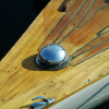 A fish-eye reflection where masts converge.