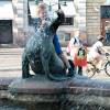 Kid wrestling one of the seals of the fountain.