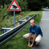 Nicolas pausing as a frog, next to the beware of the frog sign, Eltville am Rhein, Germany